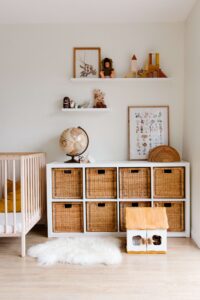 nursery painted white with natural color decorations